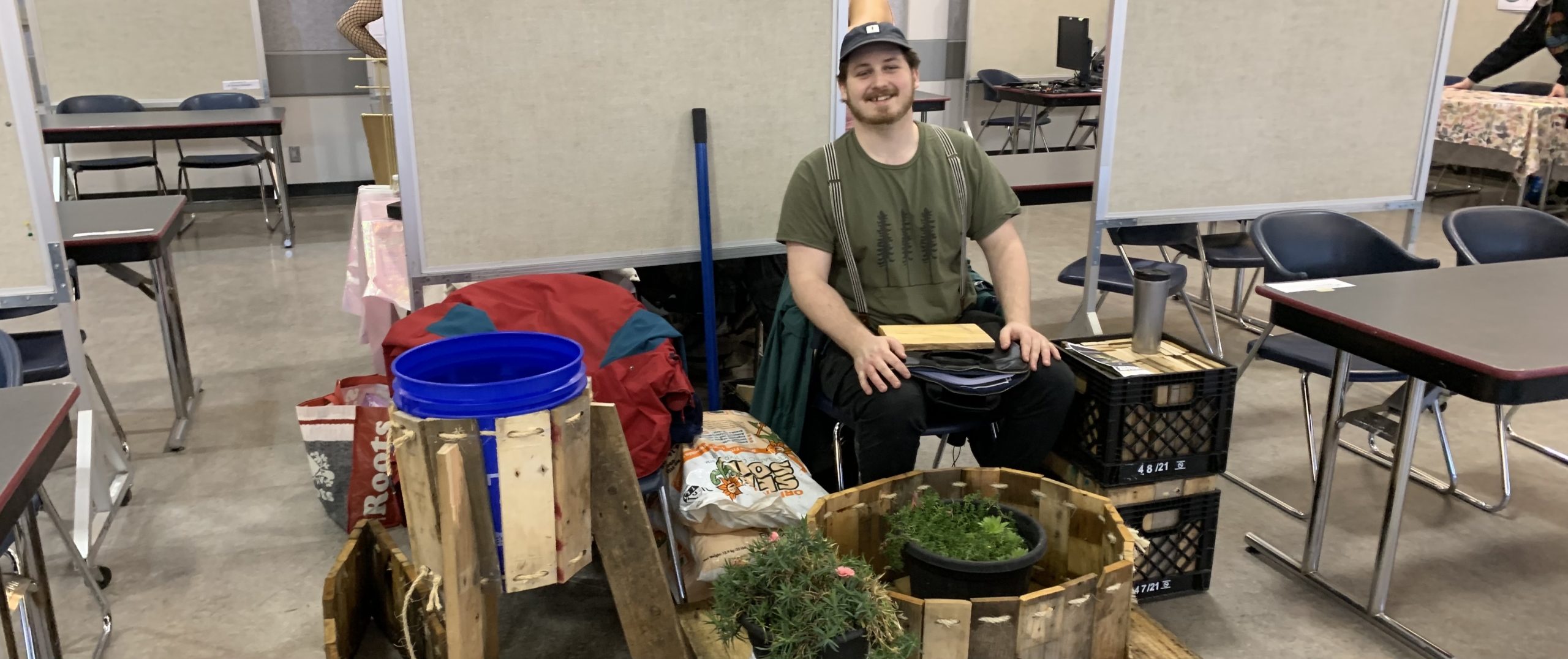 Eric holding down our Clubs Day table, sans the table, half an hour before anyone else showed up